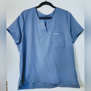 Jaanuu 1-pocket tuck in scrub top Ceil Blue in size XL
